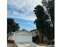 House exterior with palm trees and a fence at 1825 Ann Greta Dr, Las Vegas, NV 89108