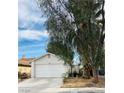 Front view of a house with a white garage at 1825 Ann Greta Dr, Las Vegas, NV 89108