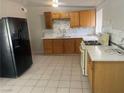 Well-lit kitchen featuring stylish countertops, wooden cabinetry, and modern black appliances at 1901 Belmont St, North Las Vegas, NV 89030