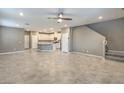 Bright and airy living room with tile floors and an open floor plan that flows into the kitchen at 2436 Padulle Pl, Henderson, NV 89044