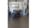 Bright dining room features an table with a bench, a sun painting, plants, and hard wood flooring at 2606 S Durango Dr # 279, Las Vegas, NV 89117