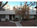 Two-story stucco building with a courtyard and trees at 2663 Aracatuba Ave, Las Vegas, NV 89121