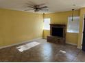 Bright living room with a brick fireplace and ceiling fan at 2663 Aracatuba Ave, Las Vegas, NV 89121