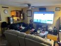 Living room with large TV, comfortable seating, and fireplace at 2663 Aracatuba Ave, Las Vegas, NV 89121