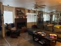 Living room with fireplace, sectional sofa, and wood rocking chair at 2686 Ruthe Duarte Ave, Las Vegas, NV 89121