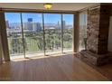 Living room with hardwood floors, fireplace and city view at 3111 Bel Air Dr # 24E, Las Vegas, NV 89109