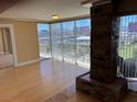 Living room with hardwood floors, fireplace and city view at 3111 Bel Air Dr # 24E, Las Vegas, NV 89109