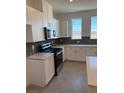Modern kitchen with white cabinets, hexagonal backsplash and stainless steel appliances at 353 Ukelele Pl # Lot 149, Henderson, NV 89015