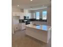 Spacious kitchen featuring white cabinets, quartz countertops, and an island at 353 Ukelele Pl # Lot 149, Henderson, NV 89015