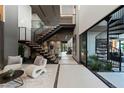 Modern entryway, featuring a floating staircase and interior courtyard at 3530 Cosima Ln, Las Vegas, NV 89120