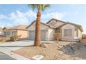 Single-story house with gray garage door and rock landscaping at 3902 Winter Whitetail St, Las Vegas, NV 89122