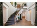 Curved staircase with ornate railing and wood flooring at 4386 Jerdon Ct, Las Vegas, NV 89129