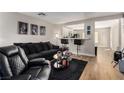 Spacious living room with black leather furniture and a view into the kitchen at 4924 Conglobate St, Las Vegas, NV 89122