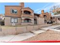 Tan two-story building with a gated entrance at 5261 Mission Carmel Ln # 202, Las Vegas, NV 89107