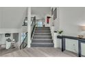 Bright foyer with modern staircase, sleek console table, and views of the pool at 6276 Olde Lockford Ct, Las Vegas, NV 89139