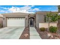 Charming single-story home featuring stone accents, a two-car garage, and well-maintained landscaping at 6886 Barred Dove Ln, North Las Vegas, NV 89084