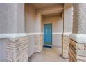 Front entry with blue door and stone columns at 723 Value Ridge Ave, Henderson, NV 89012