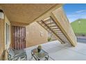 Exterior condo entry with stairs, seating, and small cactus plant at 7950 W Flamingo Rd # 1054, Las Vegas, NV 89147