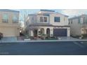 Two-story house with a front yard, attached garage, and neutral color scheme at 927 Via Canale Dr, Henderson, NV 89011