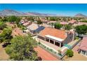 Lovely home with a covered patio and landscaped yard; mountains in the background at 9609 Eagle Valley Dr, Las Vegas, NV 89134