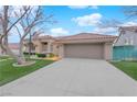 Single-story house with a red tile roof and an extended driveway leading to an attached two-car garage at 9609 Eagle Valley Dr, Las Vegas, NV 89134