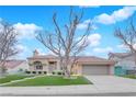 Inviting single-story home featuring a manicured lawn, tiled roof, and attached garage at 9609 Eagle Valley Dr, Las Vegas, NV 89134
