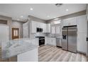 Modern kitchen with white cabinets, stainless steel appliances, and quartz countertops at 10525 Findlay Ave, Las Vegas, NV 89134