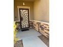 Charming front entrance with decorative security door and stone accents at 1136 Buckhorn Cove St, Henderson, NV 89011