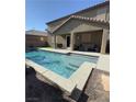 Relaxing backyard pool area features a covered patio with outdoor seating at 1136 Buckhorn Cove St, Henderson, NV 89011