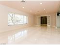 Spacious living room featuring tile floors, recessed lighting, and access to a large closet at 1403 5Th Pl, Las Vegas, NV 89104