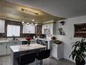 Bright kitchen with white shaker cabinets, an island, and a decorative backsplash at 2109 Juana Vista St, Las Vegas, NV 89102