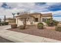 Single-story house with stone accents and a well-manicured lawn at 2608 Dearport Ct, Henderson, NV 89052