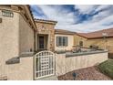 Welcoming home exterior showcasing a gated front patio and charming desert landscaping at 2608 Dearport Ct, Henderson, NV 89052