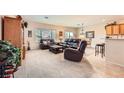 Spacious living room featuring leather furniture and a neutral color scheme at 2608 Dearport Ct, Henderson, NV 89052