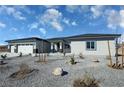 Inviting single-story home with a three-car garage and desert landscaping at 2700 W Carnation Way, Pahrump, NV 89048