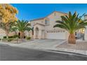 Two-story house with palm trees and a driveway at 2721 Tahiti Isle Ave, North Las Vegas, NV 89031