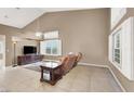 Living room with vaulted ceiling, tile floors and a neutral color scheme at 2823 Camelback Ln, Henderson, NV 89074