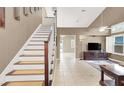 Bright, spacious entryway with a wooden staircase leading to the upper level at 2823 Camelback Ln, Henderson, NV 89074