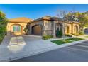 Beautiful home featuring an attached garage, decorative stone accents, and manicured front yard at 308 Bayswater Ct, Las Vegas, NV 89145