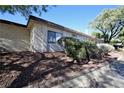 Side view showcasing stucco exterior and landscaping at 3126 Asoleado Cir, Las Vegas, NV 89121