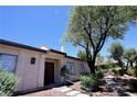 Inviting front entrance featuring a stone walkway, quaint desert plants, and double entry doors at 3126 Asoleado Cir, Las Vegas, NV 89121
