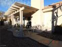 Covered patio with outdoor seating, perfect for entertaining and enjoying the desert landscape with ample shade at 3951 Candleglow Ct, Las Vegas, NV 89147