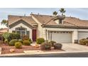 Inviting single-story home featuring a red front door, desert landscaping, and a two-car garage at 4731 Norwegian St, Las Vegas, NV 89147