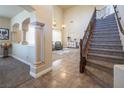 Elegant entryway with tiled floors and grand staircase at 528 Copper View St, Henderson, NV 89052