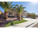 Two-story house with three-car garage and palm trees at 528 Copper View St, Henderson, NV 89052