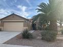 One-story house with attached garage and a palm tree in front at 551 Morning Mauve Ave, Las Vegas, NV 89183