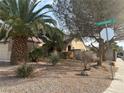 Landscaped yard with desert plants and a street sign at 551 Morning Mauve Ave, Las Vegas, NV 89183