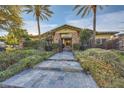 Elegant home with stone accents and landscaped entryway at 5895 S Gateway Rd, Las Vegas, NV 89120