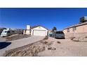 House exterior showcasing a driveway and a spacious front yard at 6166 Evensail Dr, Las Vegas, NV 89156