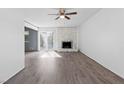 Living room with stone fireplace and sliding doors to patio at 6223 Foothill Blvd, Las Vegas, NV 89118